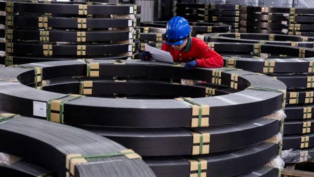 A worker checks the carbon-fiber composite made for wind blades stored at the Swancor Holding factory in Nantou, Taiwan.