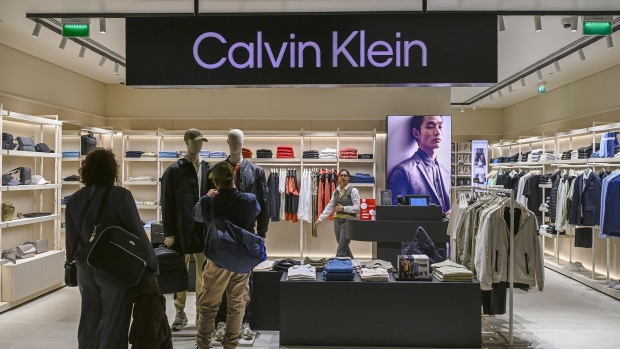 Travelers check on jackets at a Calvin Klein store in departures area of Humberto Delgado International Airport in Lisbon, Portugal, on Feb. 26. Photographer: Horacio Villalobos/Corbis News/Getty Images