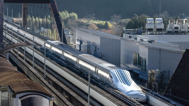 TSURU, JAPAN - DECEMBER 03: A magnetic levitation (maglev) train conducts a test run past Yamanashi Prefectural Maglev Exhibition Center on December 3, 2021 in Tsuru, Japan. The 95 billion USD magnetic levitation (maglev) train line linking Tokyo with Nagoya is being held in limbo after the governor of Shizuoka Prefecture refused to allow construction for what will be one of the world's fastest trains. Concerns were raised that construction work could affect the volume of water on the Oigawa river which runs through the prefecture. (Photo by Carl Court/Getty Images)