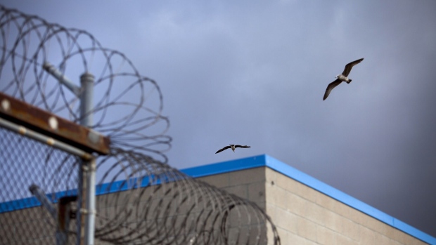 Barbed wire on top of fences at a correctional facility. Photographer: Sam Hodgson/Bloomberg