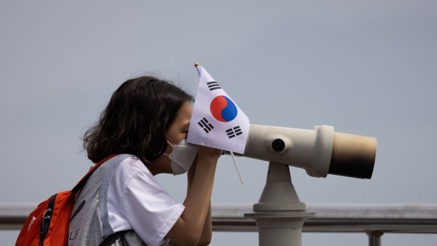 A visitor uses binoculars looking toward the Naro Space Center in Goheung in May.