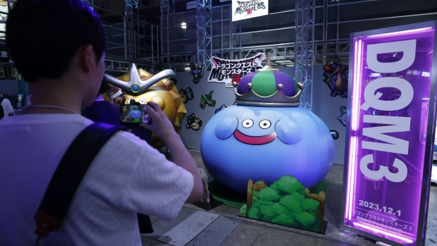 An attendee uses a smartphone to take a photograph of an inflatable figurine of the Dragon Quest series monster King Slime in the Square Enix Co. booth at the Tokyo Game Show in Chiba, Japan, on Thursday, Sept. 21, 2023. The show runs through to Sept. 24. Photographer: Kiyoshi Ota/Bloomberg