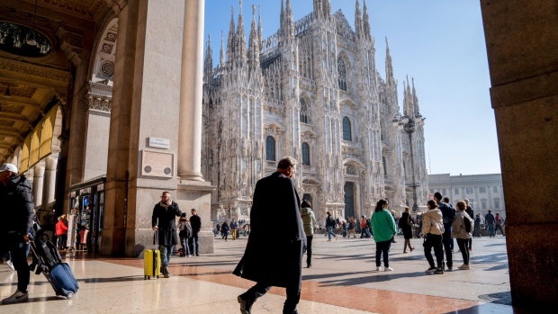 <p>Pedestrians pass near the Duomo Cathedral in Piazza Duomo in Milan, Italy.</p>