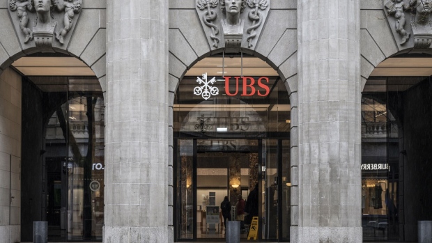 A logo above the entrance to the UBS Group AG headquarters in Zurich, Switzerland, on Monday, March 18, 2024. The Swiss National Bank will announce interest rates on March 21. Photographer: Pascal Mora/Bloomberg