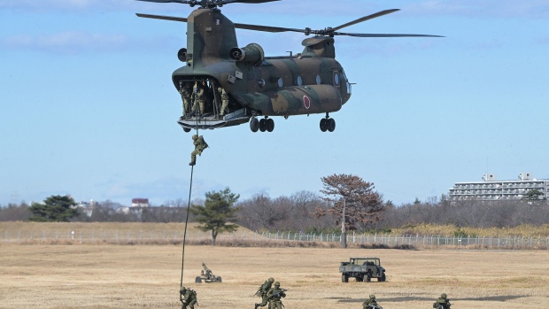 Troops descend from a helicopter during a joint military drill at Camp Narashino in Funabashi, Chiba prefecture, Japan on Jan. 7, 2024. Photographer: Richard A. Brooks/AFP/Getty Images