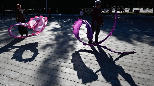People dance with long ribbons at a park in Beijing, China, on Wednesday, Jan. 24, 2024. China's population declined at a faster pace in 2023 as births fell to a record low, accelerating a demographic shift that poses long-term challenges to a government already contending with deflation pressures and a property crisis. Bloomberg