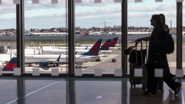 Delta passenger jets at LaGuardia Airport. Photographer: Angus Mordant/Bloomberg