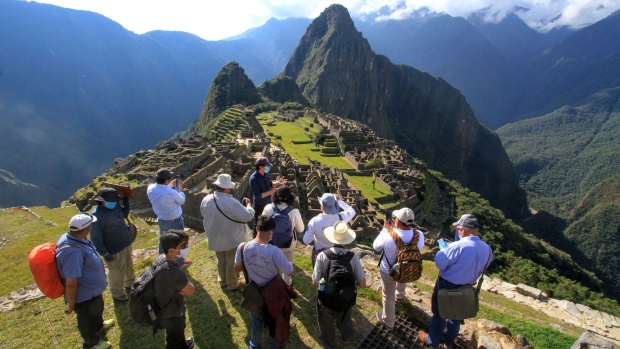 Tourists visit the Inca citadel of Machu Picchu. Photographer: Percy Hurtado/AFP/Getty Images