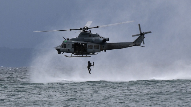 A Philippines marine jumps off from a US helicopter during a training exercise in Ternate town, north of Manila in 2023. Photographer: Ted Aljibe/AFP/Getty Images
