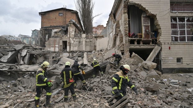 TOPSHOT - Ukrainian rescuers work at the site of a missile attack in Kyiv. Photographer: Sergei Supinsky/AFP/Getty Images