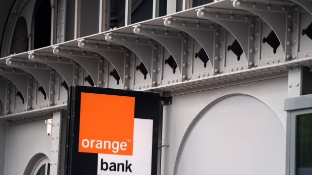 An Orange Bank sign outside the Orange SA headquarters in Paris, France, on Wednesday, April 26, 2023. Orange reported sales in line with its 2023 targets and just below analyst estimates in the first quarter, as a price increase to counter inflation led to a slight increase in the number of mobile customers who left the French carrier. Photographer: Nathan Laine/Bloomberg