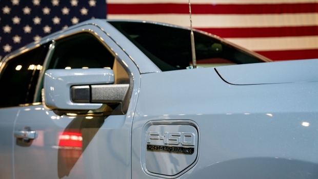 A Ford Motor Co. F-150 Lightning electric vehicle (EV) during an event at the DC Armory in Washington, DC, US, on Wednesday, March 20, 2024. The Biden administration moved Wednesday to throttle pollution from the nation's cars and light trucks, imposing tailpipe emission limits so stringent they will compel automakers to rapidly boost sales of battery electric and plug-in hybrid models. Photographer: Kent Nishimura/Bloomberg