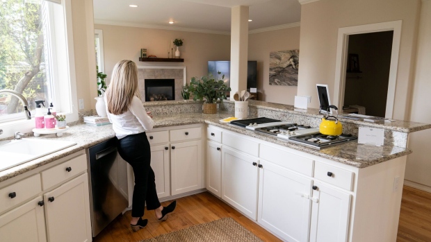 <p>A realtor stands in the kitchen of a home during an open house in Seattle, Washington. </p>