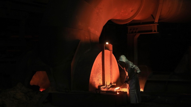An employee takes a sample of molten iron from a blast furnace at the Thyssenkrupp plant in Duisburg, Germany. Photographer: Krisztian Bocsi/Bloomberg
