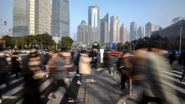 Pedestrians cross a road in Pudong's Lujiazui Financial District in Shanghai, China, on Tuesday, Jan. 9, 2024.  Photographer: Qilai Shen/Bloomberg