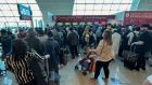Passengers queue at a flight connection desk at Dubai International Airport on April 17. Source: AFP/Getty Images