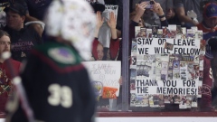 Fans of the Arizona Coyotes hold up signs before a home game played at Arizona State University’s 5,000-seat arena.  Photographer: Christian Petersen/Getty Images