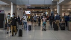 Travelers at the departures concourse of Miami International Airport (MIA) in Miami, Florida, U.S., on Monday, April 18, 2022. 