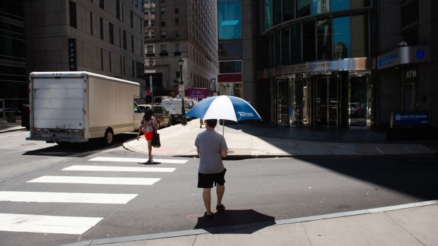 <p>A pedestrian carries an umbrella to shade himself from the sun during a heat wave in Philadelphia on July 28, 2023. </p>
