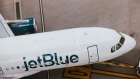 A JetBlue passenger jet at LaGuardia Airport. Photographer: Angus Mordant/Bloomberg