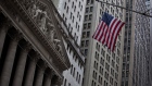 An American flag flies across from the New York Stock Exchange (NYSE) in New York, U.S., on Friday, May 4, 2018. U.S. stocks recovered from early-session losses after testing a key technical level, as investors weighed an April U.S. jobs report that showed an 18-year low in the unemployment rate. Photographer: Michael Nagle/Bloomberg
