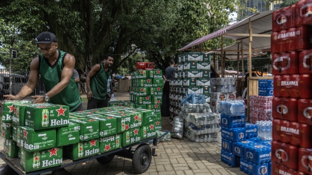 Delivery workers unload a truck of beer ahead of a street music show at Gloria beach in Rio de Janeiro on April 14.