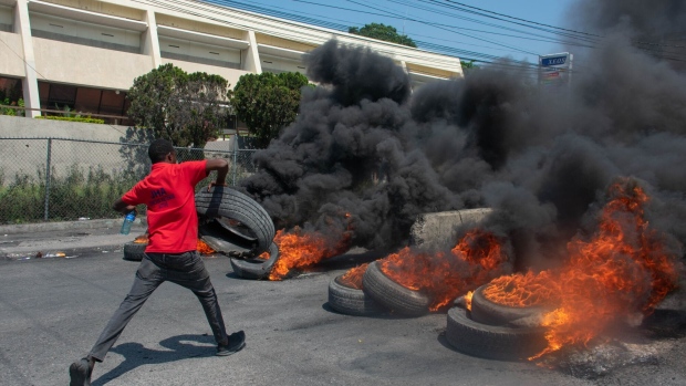 A protester burns tires during a demonstration following the resignation of Ariel Henry in Port-au-Prince, Haiti on March 12. Photographer: Clarens Siffroy/AFP/Getty Images