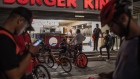 Food app delivery workers wait outside a Burger King Corp. restaurant in Sao Paulo, Brazil, in April, 2020.