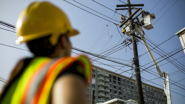<p>Puerto Rico Electric Power Authority employees fix power lines in Santurce, Puerto Rico.</p>