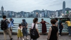 Tourists on the promenade in the Tsim Sha Tsui area of Hong Kong.