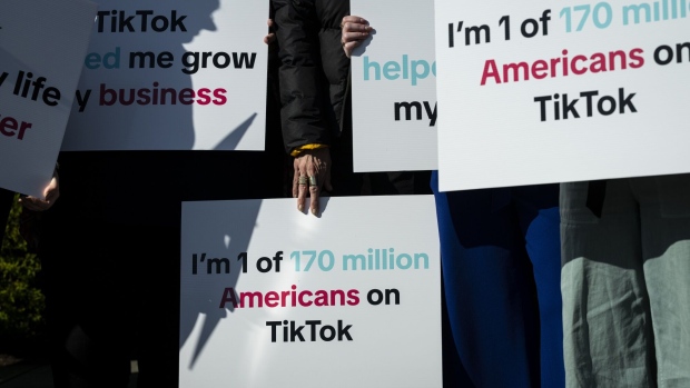 A group of Tik Tok creators and advocates hold signs before a news conference outside the US Capitol in Washington, DC, US, on Tuesday, March 12, 2024. Renewed efforts by Congress to force TikTok to sell or face a ban in the US have the backing of the White House, even as President Joe Biden's reelection campaign has started to use the platform to reach younger voters. Photographer: Graeme Sloan/Bloomberg