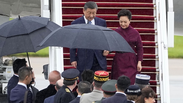 Xi Jinping and his wife Peng Liyuan disembark upon their arrival at Orly airport in Paris on May 5. Photographer: Michel Euler/AFP/Getty Images