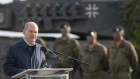 <p>Olaf Scholz speaks with soldiers of the Bundeswehr at the Bundeswehr army training center in Ostenholz, Germany.</p>