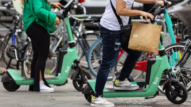 <p>Customers ride Bolt electric scooters in Berlin, Germany.</p>