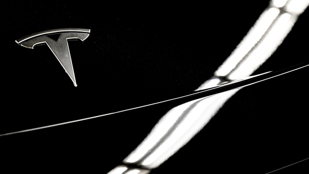A 2024 Tesla Model 3 during the Montreal Electric Vehicle Show in Montreal, Quebec, Canada, on Friday, April 19, 2024. Prime Minister Justin Trudeau is offering more tax breaks to automotive firms to put their electric vehicle factories in Canada, as companies including Honda Motor Co. and Toyota Motor Corp. consider lucrative new investments. Photographer: Graham Hughes/Bloomberg