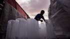 <p>A man unloads blocks of ice from a truck during high temperatures in Bangkok on April 28.</p>