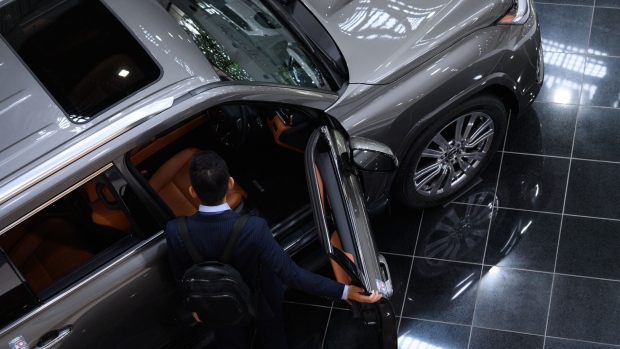 A visitor looks at a Toyota Motor Corp. Lexus LX600 vehicle at the company's showroom in Toyota City, Aichi Prefecture, Japan, on Monday, June 13, 2022. Toyota will hold its annual shareholders' meeting on June 15. Photographer: Akio Kon/Bloomberg