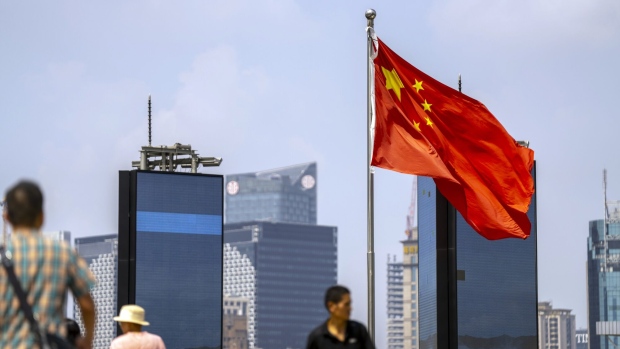 A Chinese flag in Pudong's Lujiazui Financial District in Shanghai, China, on Monday, Sept. 18, 2023. China's economy picked up steam in August as a summer travel boom and a heftier stimulus push boosted consumer spending and factory output, adding to nascent signs of stabilization.