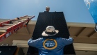 <p>Workers install solar panels during a SunPower installation on a home in Napa, California.</p>