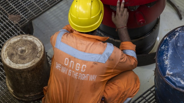 A worker inspects a land drilling oil rig, manufactured by Megha Engineering and Infrastructures Ltd. (MEIL) and operated by Oil and Natural Gas Corp., during a media tour in Bhimavaram, Andhra Pradesh, India, on Tuesday, March 8, 2022. MEIL has supplied 10 land drilling oil rigs to ONGC, with three already in operation, according to a company statement. Photographer: Sumit Dayal/Bloomberg
