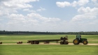 A tractor collects bales of hay during a heatwave outside Elgin, Texas, US, on Wednesday, July 20, 2022. In Texas 100-degree Fahrenheit temperatures plus the soaring costs for feed, fertilizer, fuel and the lack of water and hay have made it too expensive for farmers to sustain livestock. Photographer: Sergio Flores/Bloomberg