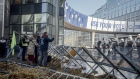 Farmers protest near dumped hay outside the European Parliament in Brussels, on Feb. 1. Photographer: Cyril Marcilhacy/Bloomberg