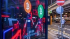 Bitcoin logos on a screen in Hong Kong. Photographer: Paul Yeung/Bloomberg