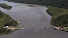 Crews work to clean up an oil spill on the North Saskatchewan river