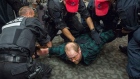A demonstrator is arrested after disrupting the NEB public hearing in Montreal Monday, Aug. 29. 