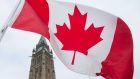 The Canadian flag flies on Parliament Hill