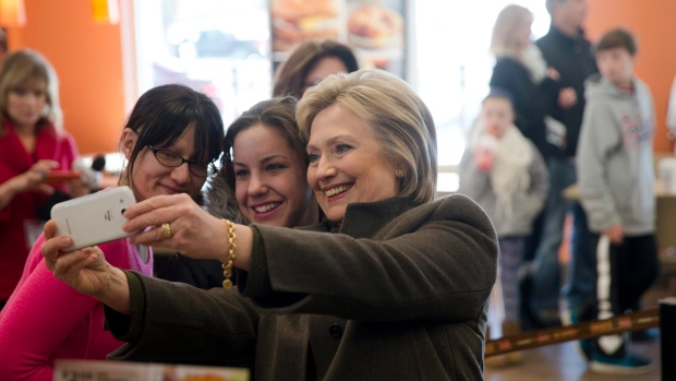 Hillary Clinton takes a selfie at a Dunkin' Donuts in Manchester, N.H.