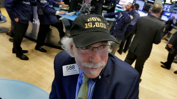 Trader Peter Tuchman wears his "Dow 19,000" cap on the floor of the New York Stock Exchange