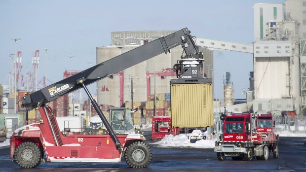 Trucks unload containers from cargo ships in the Port of Montreal