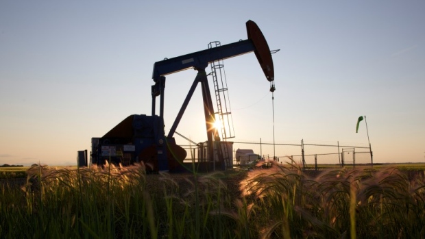 An oil pump jack pumps oil in a field near Calgary, Alberta